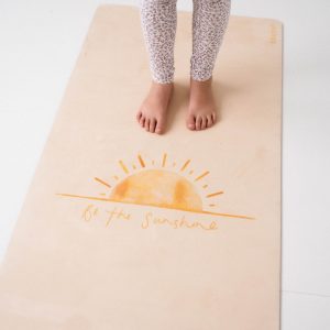 Be the Sunshine pilates mat with feet standing on it
