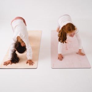 two children doing pilates on mats